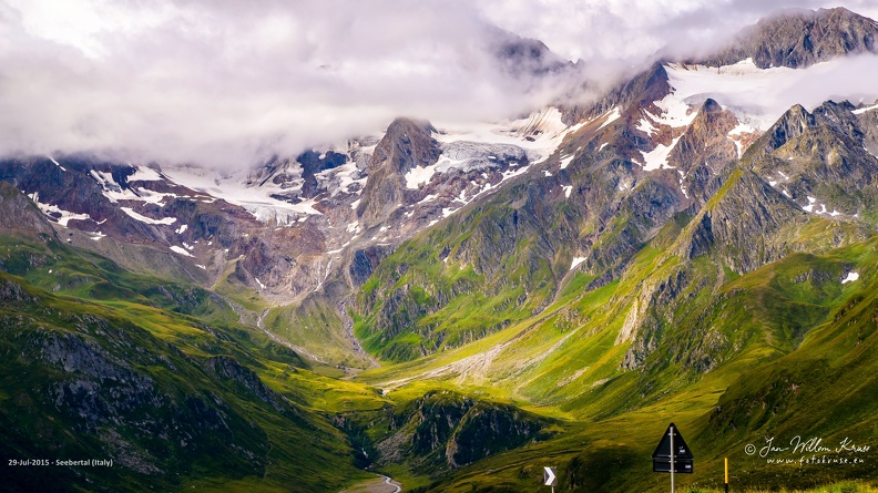 Seebertal (Italy) - GFK-20150729-D800-3628-wallpaper-16_9.jpg High mountain peaks with glaciers in the clouds with morning sun peaking through as seen from the Timmelsjoch pass in Austria
