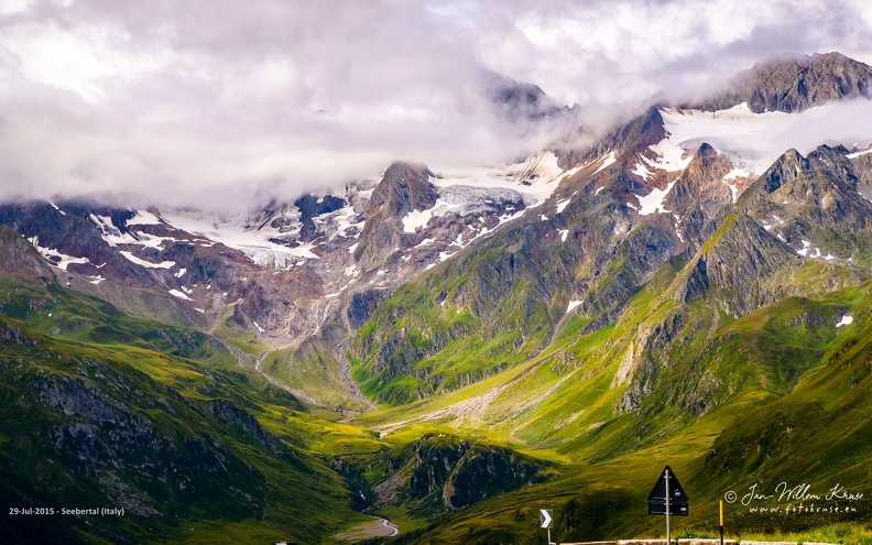 Seebertal (Italy) - GFK-20150729-D800-3628-wallpaper-16_10.jpg High mountain peaks with glaciers in the clouds with morning sun peaking through as seen from the Timmelsjoch pass in Austria