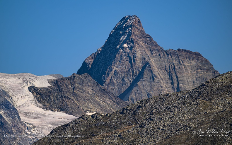 The Matterhorn, a mountain shaped like an Egyptian pyramid, is 4478 metres high (14692 ft) located at the border between Switserland and Italy nearby the Swiss town of Zermatt in the Mattertal valley in the canton of Valais.
The Matterhorn has four faces nearly facing the four compass points. Three of them (north, east and west) are on the Swiss side of the border and one of them (south) is on the Italian side of the border in the Valtournenche valley. From the area of Zermatt the east and north faces are visible.
The Matterhorn's faces are steep, and only small patches of snow and ice cling to them; regular avalanches send the snow down to accumulate on the glaciers at the base of each face. The mountain has two distinct summits, situated at either end of a 100-metre-long (330 ft) exposed rocky crest which forms the Italian/Swiss border.
Millions of years ago, it was part of the African continent. Nowadays it is one of the most famous mountains in the world and is the best-known landmark in Switzerland. North-West side of the Matterhorn (taken from 32km distance)