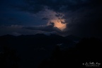 At end of sunset last bit of sun beams into a cloud