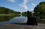 Woman overlooking a pond in a landscaped nature park