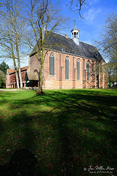 Red-brick Gothic Boschkerk at Klooster Ter Apel with tall pointed windows and a small roof turret.