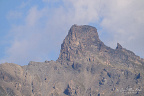 Rocky Alpine Summit in Cloud (16 visits) A rugged isolated rock summit emerges through drifting cloud above a barren alpine ridge. Rocky Alpine Summit in Cloud