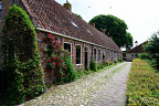 Historic Brick Houses inside Vesting Bourtange (6 visits) Low brick houses with red tile roofs and climbing roses line a cobbled lane inside Vesting Bourtange... Historic Brick Houses inside Vesting Bourtange