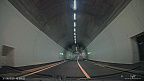 Driving through a Modern Road Tunnel (6 visits) A vehicle travels through a modern, brightly lit two-lane road tunnel with white wall panels and ove... Driving through a Modern Road Tunnel